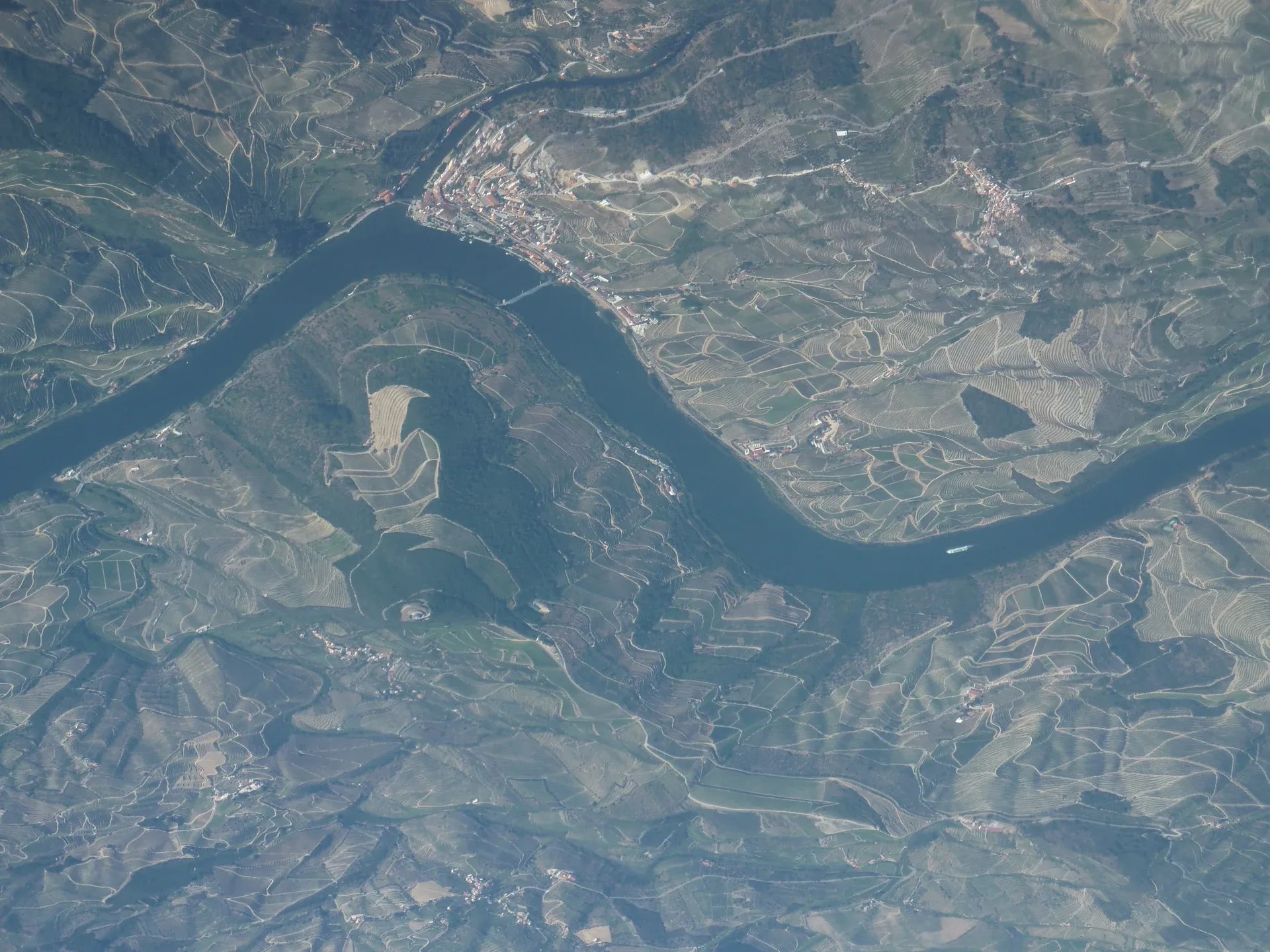 Aerial view of the Douro at Pinhão, between the town and the vineyard-covered hillsides.